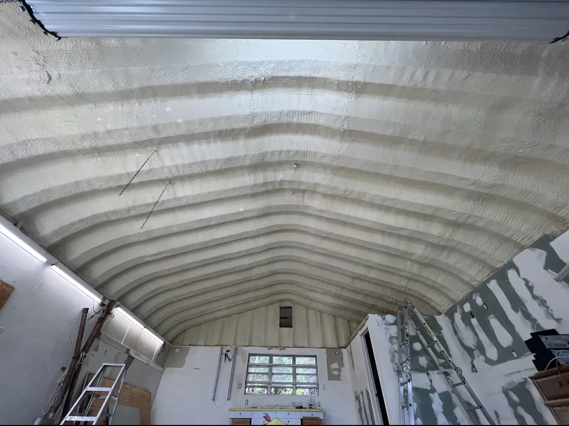 Spray polyurethane foam applied to the underside of a metal roof deck in Bernards